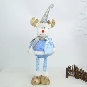 Όρθιο χριστουγεννιάτικο λούτρινο ελάφι με μπλε πουλόβερ με πούλιες και τσάντα δώρου.
