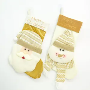 Detailed view of two plush Christmas stockings with Santa Claus and Snowman motifs