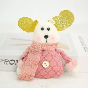 Detailed macro shot of a cute pink Christmas plush doll featuring golden sequin heart ears