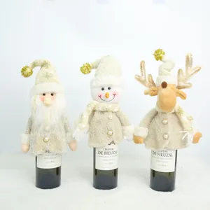 Detailed shot of three plush Christmas wine bottle covers featuring Santa, Snowman and Reindeer.