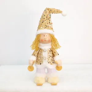 Detail of a Christmas girl plush doll with golden sequins and ski accessories.