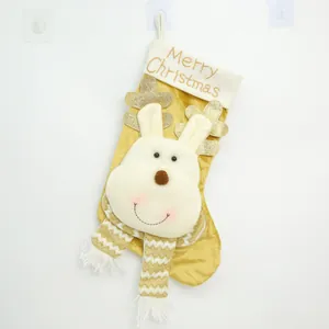 Detail view of gold Christmas stocking with plush reindeer and Merry Christmas embroidery