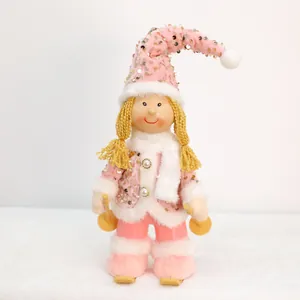 Detailed view of pink sequined Christmas girl doll with ski poles and fuzzy white scarf