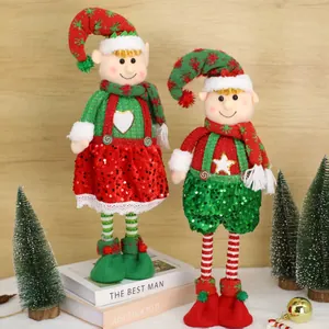 Paar feestelijke kerstelf pluche poppen met rode en groene pailletten kledingstukken