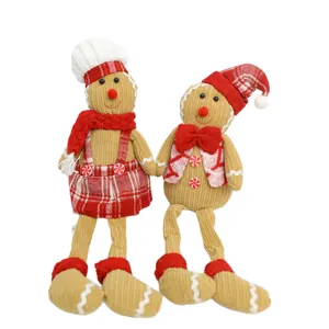 Pair of festive corduroy gingerbread man dolls with red chef hats and plaid outfits