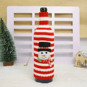 Decorative Christmas red and white striped knitted wine bottle cover with a cute snowman design