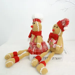 Pair of Christmas corduroy gingerbread dolls in chef and Santa styles on white prop