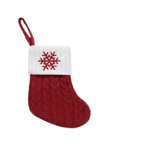 Classic red knitted Christmas stocking with white cuff and embroidered red snowflake
