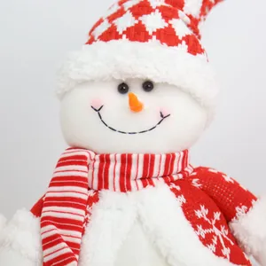 Detailed view of a plush Christmas snowman with a red striped scarf and knitted sweater