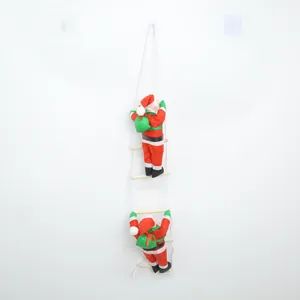 Close-up of two Santa Claus dolls climbing a white rope ladder for Christmas decor