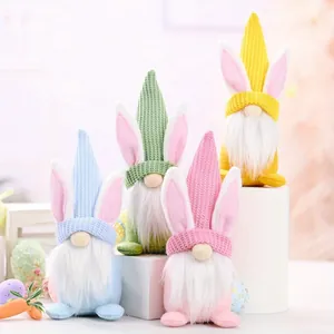 Decorative set of four Easter gnomes with bunny ears and knitted hats for festive table