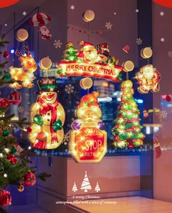 Festive glowing Christmas window hanging lights with Santa Claus and snowman patterns