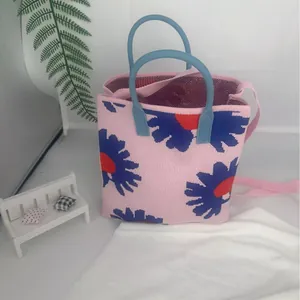 Floral pattern knitted handbag with dual handles and crossbody strap in pink and blue