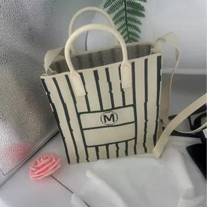 Striped knitted mini tote bag with crossbody strap and M logo