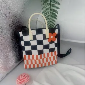 Handmade knitted checkerboard crossbody bag for phone with cute orange flower applique