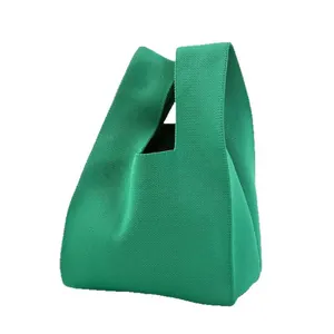Petit sac à poignet en maille vert vif avec une poignée minimaliste pour l'été