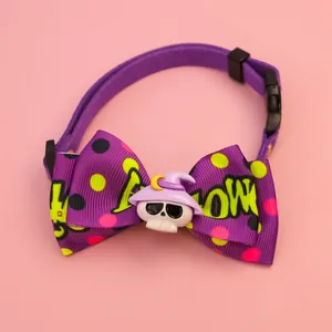 Gros plan d'un collier d'Halloween violet pour animaux avec nœud à pois et crâne mignon.