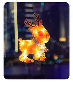 Detailed view of the warm glowing LED reindeer window hanging ornament at night
