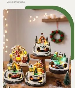Lifestyle scene showing multiple luminous Christmas snow village resin ornaments on wooden stands.