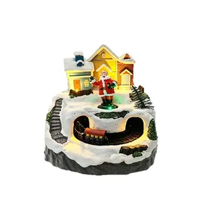 Glowing Christmas village scene with rotating train and Santa Claus music box.