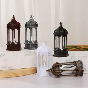 Variety of retro hexagonal LED candle lanterns displayed on marble and wood surface