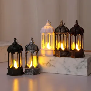 Variety of vintage electronic candle lanterns in different colors displayed on marble.