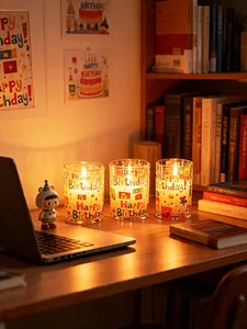 Warm atmosphere LED birthday candles with colorful Happy Birthday prints on desk