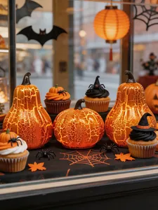 Exhibición decorativa de Halloween con calabazas de vidrio y accesorios de cupcakes