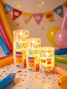 Detailed view of three Happy Birthday LED candles with colorful festive prints
