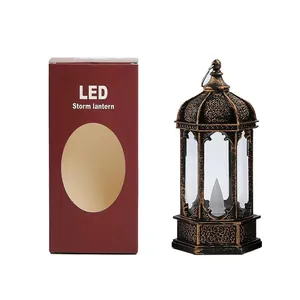 Vintage bronze hexagonal LED candle lantern shown next to its maroon packaging box