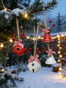 Gros plan de cloches de Noël rouges et blanches avec nœuds écossais sur sapin enneigé