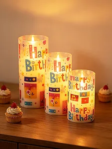 Three sizes of LED birthday candles with colorful Happy Birthday text on a wooden table