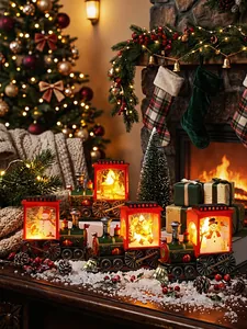 Festive Christmas LED train lanterns with snowman patterns on a snowy holiday table