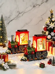Detailed view of two Christmas LED train night lights with Santa and Snowman in a snowy scene