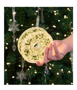 Close-up of warm white LED string lights on a spool for Christmas tree decor