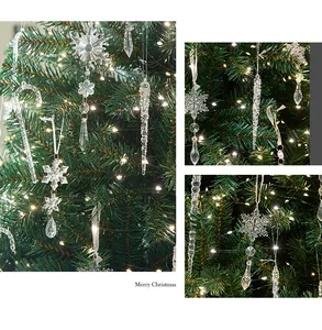 Detail showing clear acrylic snowflake and icicle ornaments hanging on a lit Christmas tree