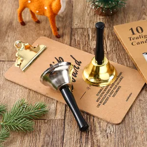 Detailed shot of gold and silver Christmas hand bells with smooth black handles