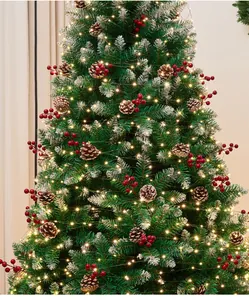 Close-up of a festive Christmas tree featuring pine cones, red berries and LED lights