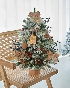 Mini flocked Christmas tree detail with pinecones and LED wooden house ornament