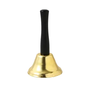 Detail shot of a classic gold Christmas hand bell with a long black handle