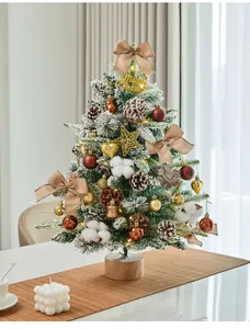 Detailed view of a mini flocked Christmas tree with warm LED lights and festive ornaments