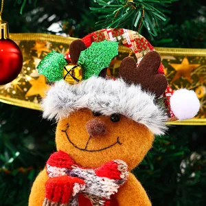 Close-up of festive reindeer plush ornament with golden bell and holly detail