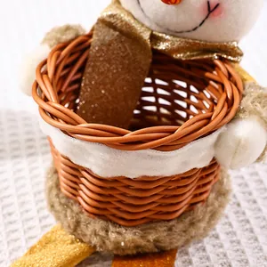 Close-up detail of a woven Christmas fruit basket with festive snowman fabric accents.