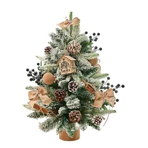 Snow-flocked tabletop Christmas tree with pinecones, burlap bows, and LED house ornament