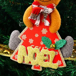Close-up of a festive gingerbread Christmas ornament with golden Noel glitter text.