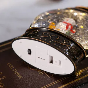 Detail view of the battery compartment and switch on a Christmas water lantern base