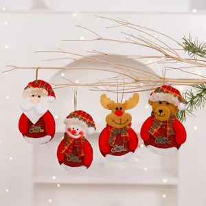 Four plush Christmas ornaments including Santa and Reindeer hanging on a decorative branch.