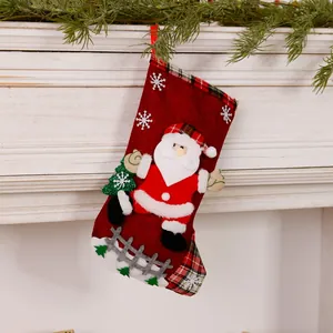 Detail of a festive red linen Christmas stocking featuring a 3D Santa Claus applique