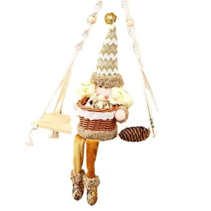 Handmade Christmas Santa gnome plush figure in wicker fruit basket on decorative swing seat