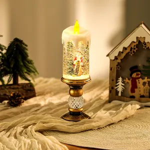 Detailed close-up view of a lit Christmas water candle featuring a Santa Claus snow globe scene